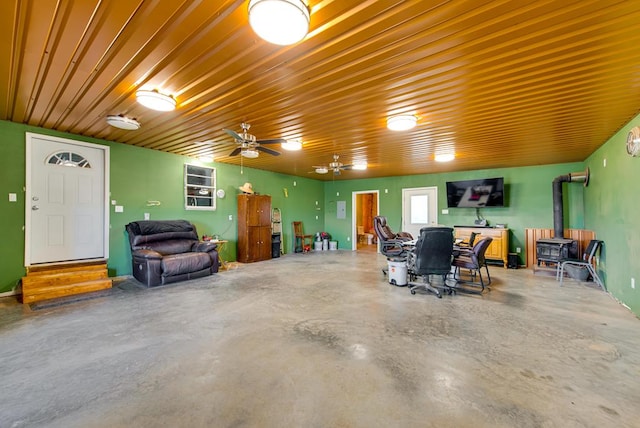 707 E County Rd 132, Midland, TX 79706 - garage featuring a wood stove and ceiling fan