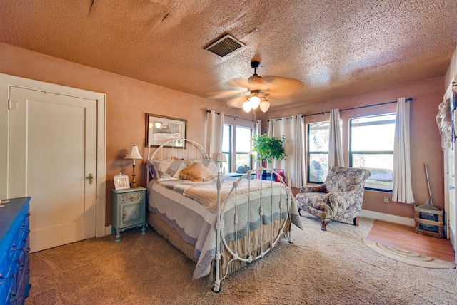 707 E County Rd 132, Midland, TX 79706 - bedroom featuring carpet flooring, a textured ceiling, and a ceiling fan