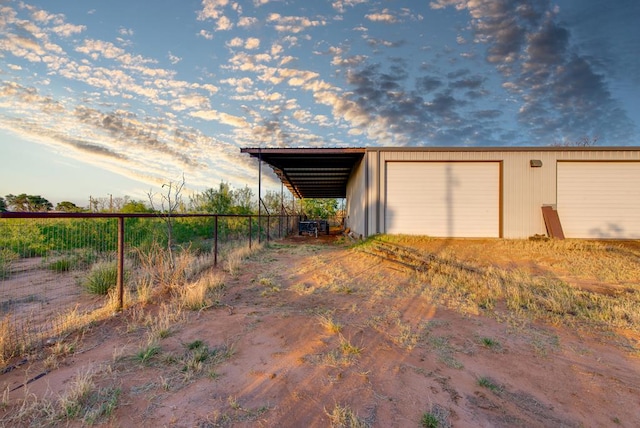 707 E County Rd 132, Midland, TX 79706 - garage featuring fence, driveway, and a detached garage