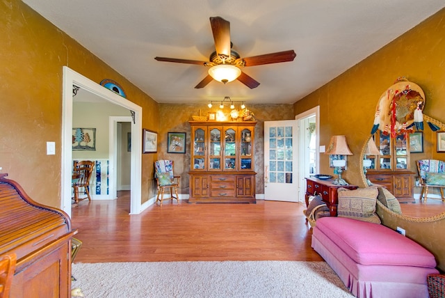 707 E County Rd 132, Midland, TX 79706 - living area featuring a ceiling fan, wood finished floors, and baseboards
