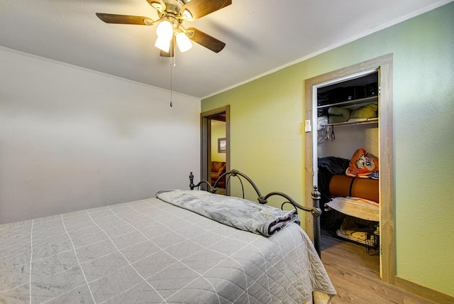707 E County Rd 132, Midland, TX 79706 - bedroom with crown molding, light wood-style floors, a closet, and a ceiling fan