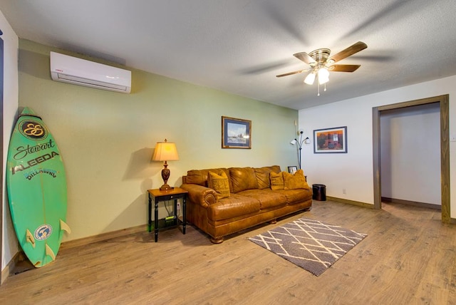 707 E County Rd 132, Midland, TX 79706 - living area with a wall unit AC, ceiling fan, wood finished floors, and baseboards