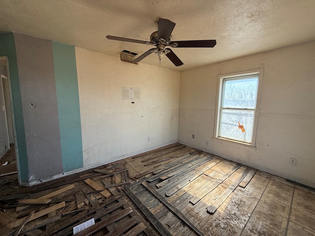 spare room featuring ceiling fan and a textured ceiling