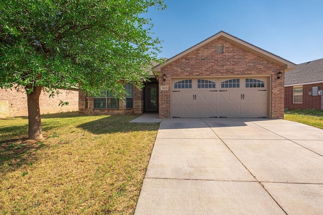 ranch-style house with brick siding, an attached garage, driveway, and a front yard