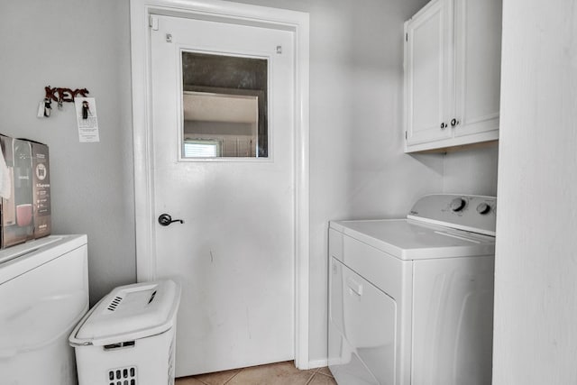 3612 Parkway Rd, Big Spring, TX 79720 - laundry area with cabinet space, washing machine and clothes dryer, and light tile patterned flooring