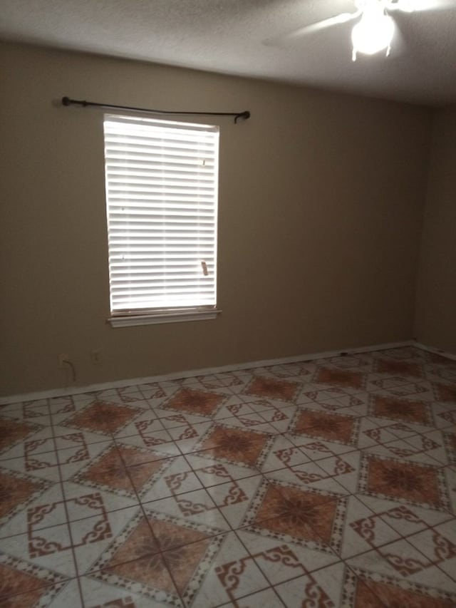 1607 E Pecan Ave, Midland, TX 79705 - tiled spare room featuring ceiling fan