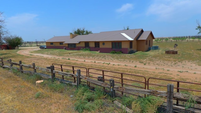 view of front of home with a rural view