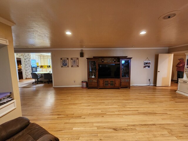 living room featuring light hardwood / wood-style floors and crown molding