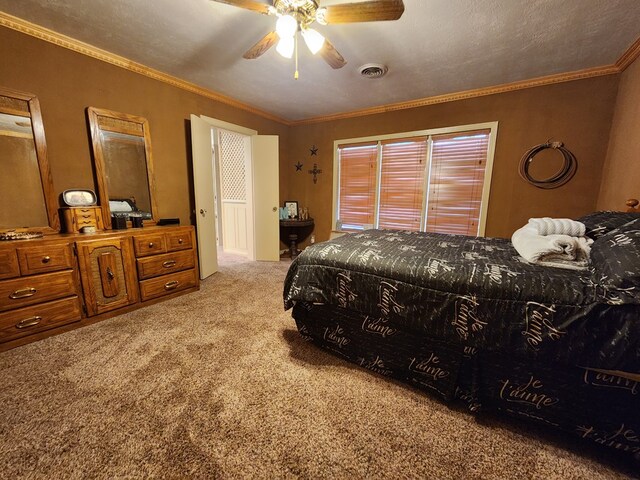 carpeted bedroom featuring a textured ceiling, ceiling fan, and crown molding