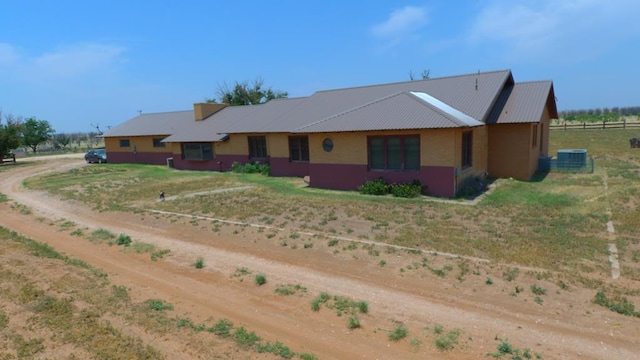 view of front of property featuring a rural view and central air condition unit