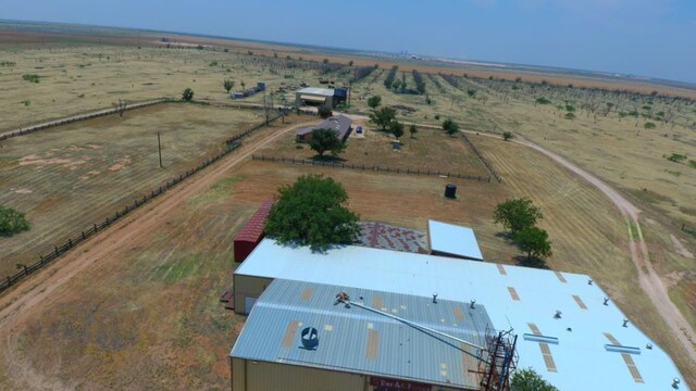 birds eye view of property with a rural view