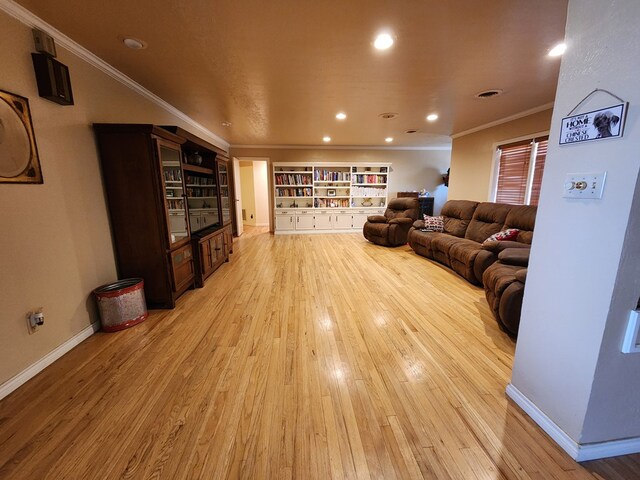 living room featuring light wood-type flooring and crown molding