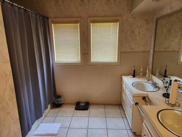 bathroom with tile patterned floors, vanity, and tile walls