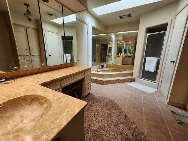 bathroom with tile patterned floors, vanity, and independent shower and bath