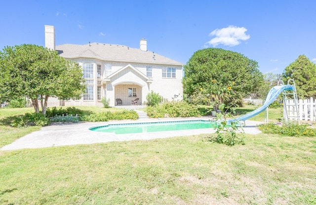 209 Bayberry Pkwy, Midland, TX 79705 - rear view of house with a yard, an outdoor pool, and a chimney
