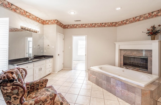 209 Bayberry Pkwy, Midland, TX 79705 - bathroom with a bath, tile patterned floors, vanity, and a high end fireplace