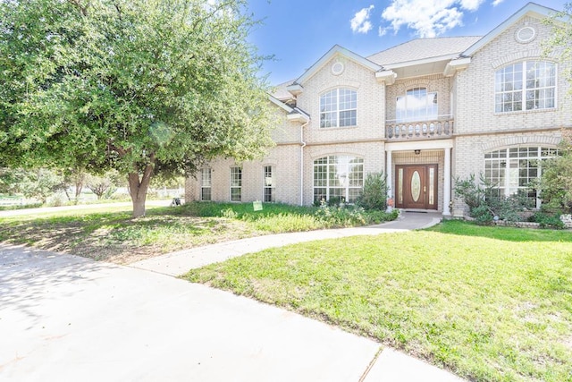 209 Bayberry Pkwy, Midland, TX 79705 - georgian-style home featuring brick siding and a front lawn