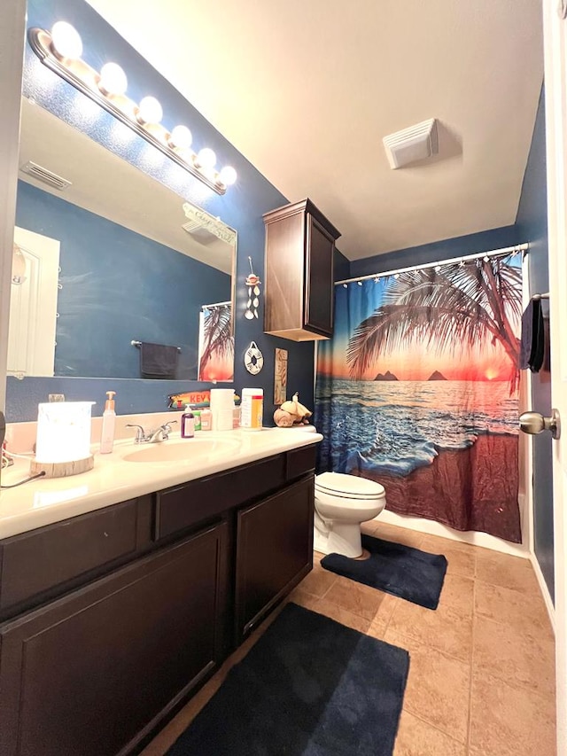 bathroom featuring tile patterned floors, vanity, and toilet