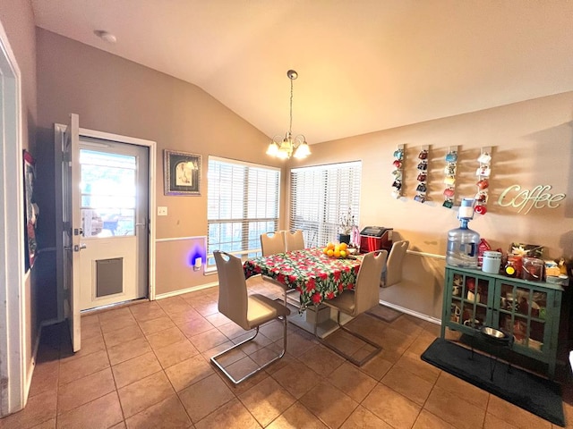 tiled dining room with lofted ceiling and a chandelier