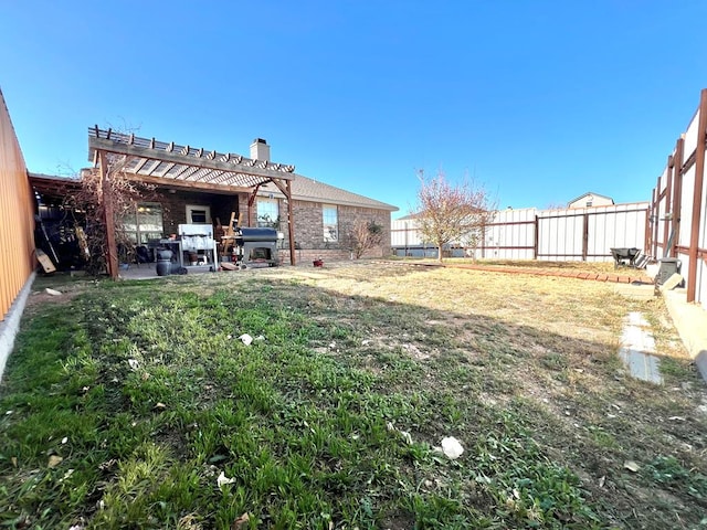 view of yard with a pergola and a patio