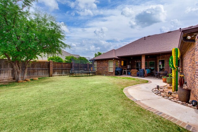 1102 Castle Rock Ct, Midland, TX 79705 - view of yard with a trampoline and a patio area