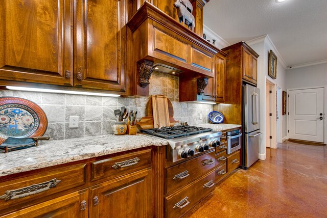 1102 Castle Rock Ct, Midland, TX 79705 - kitchen with stainless steel appliances, ornamental molding, decorative backsplash, light stone countertops, and finished concrete flooring