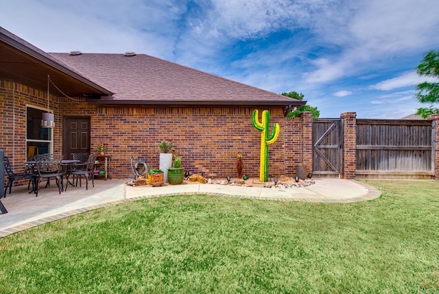 view of yard with a gate and a patio