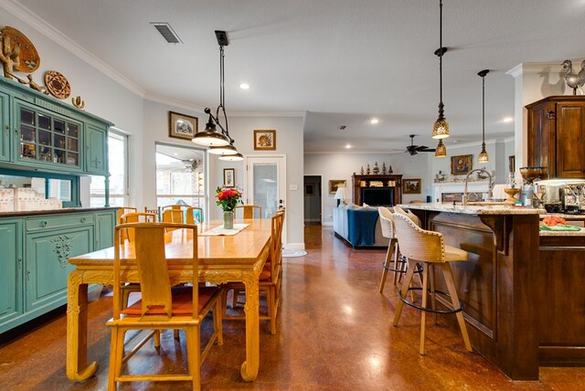 1102 Castle Rock Ct, Midland, TX 79705 - dining area featuring a ceiling fan, crown molding, concrete floors, and recessed lighting