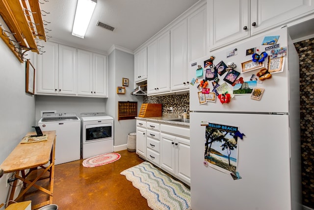 washroom featuring separate washer and dryer and a sink