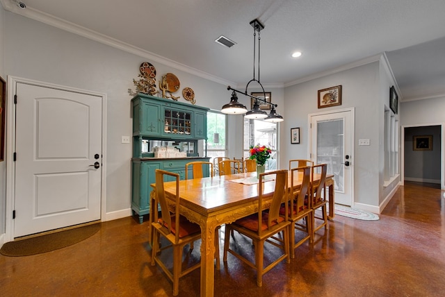 dining area with finished concrete flooring, crown molding, baseboards, and recessed lighting