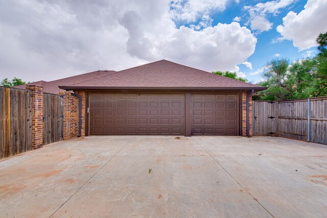 1102 Castle Rock Ct, Midland, TX 79705 - garage with a gate, fence, and driveway