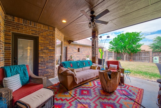 view of patio featuring outdoor lounge area, a fenced backyard, and ceiling fan