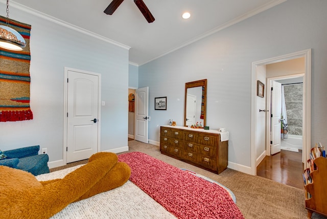 carpeted bedroom with ornamental molding, baseboards, and ceiling fan