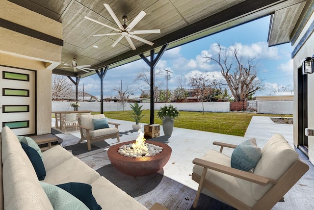 view of patio with an outdoor living space with a fire pit, ceiling fan, and a fenced backyard