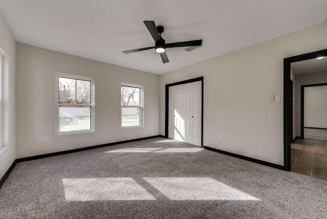 unfurnished bedroom with baseboards, a closet, ceiling fan, and carpet floors