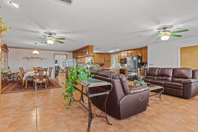 tiled living room featuring a textured ceiling