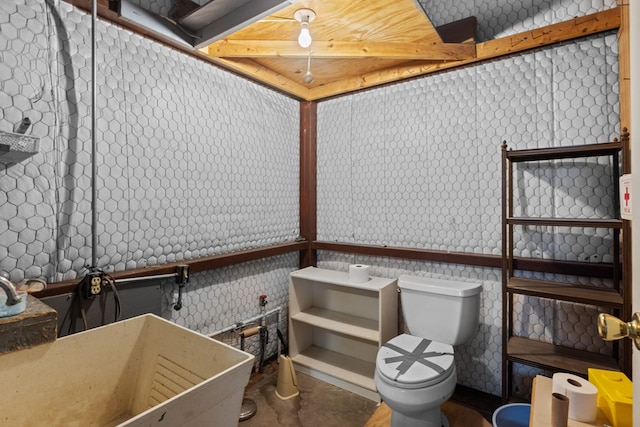 bathroom featuring toilet and concrete floors