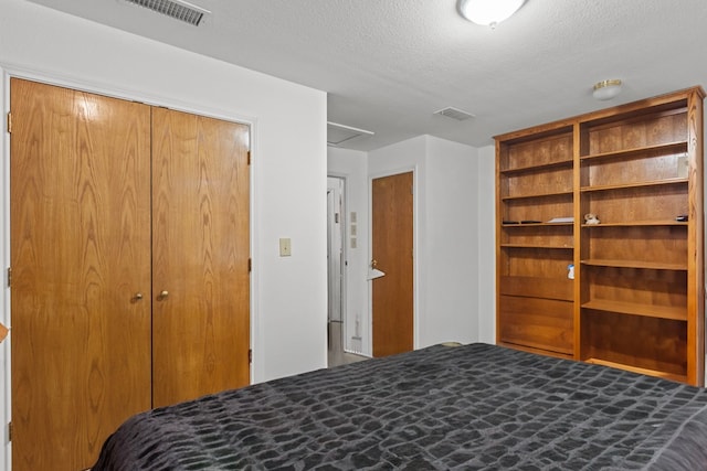 unfurnished bedroom with a textured ceiling and a closet