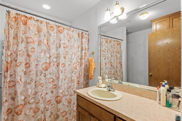 bathroom featuring a shower with curtain and vanity