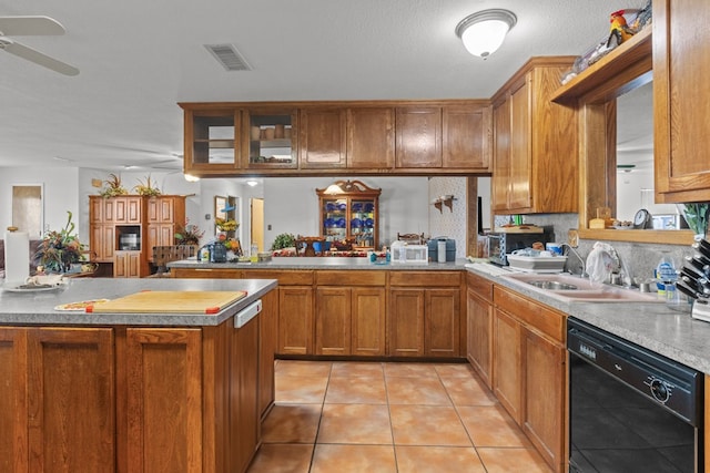 kitchen featuring sink, ceiling fan, light tile patterned floors, black dishwasher, and kitchen peninsula