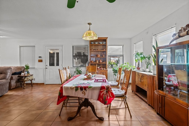 dining space with light tile patterned floors and a textured ceiling