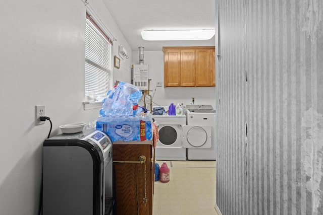 clothes washing area featuring cabinets and independent washer and dryer