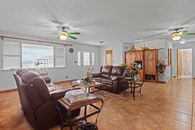 living room with light tile patterned floors and a textured ceiling