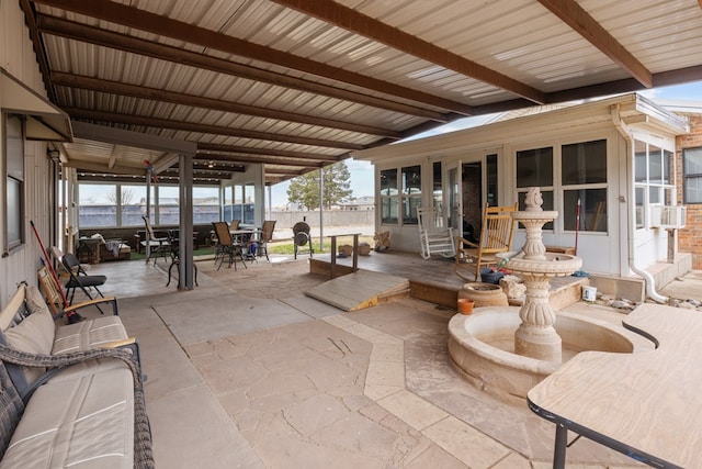 exterior space featuring lofted ceiling with beams and a healthy amount of sunlight