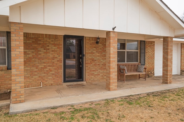 view of exterior entry featuring a porch