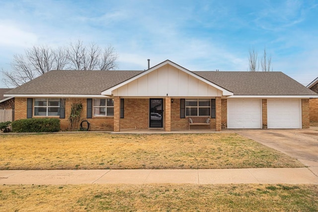 single story home with a garage, a porch, and a front yard