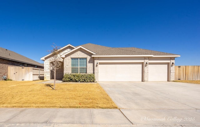 single story home featuring a garage and a front yard