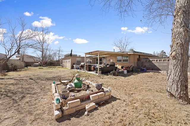 rear view of house featuring a patio and fence