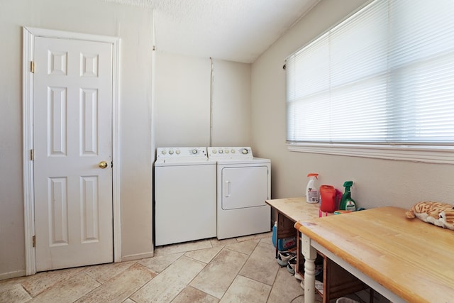 laundry area with a textured ceiling, laundry area, and washing machine and clothes dryer