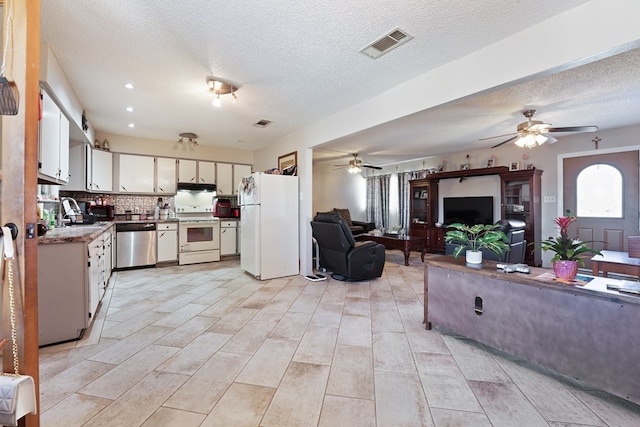 kitchen featuring white appliances, visible vents, decorative backsplash, under cabinet range hood, and open floor plan